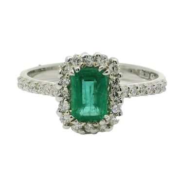Anello oro bianco 18K con smeraldo emerald centrale con contorno e gambo di diamanti